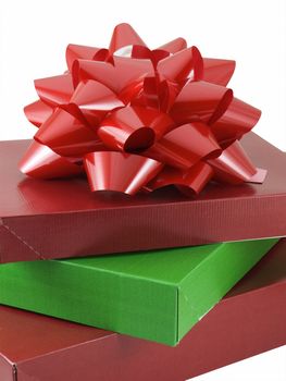 Three christmas presents with a red bow isolated on white