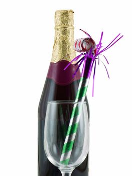 Bottle of champagne with a glass and party favor, isolated on white