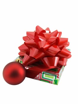 Christmas present with a large red bow and ornament isolated on white