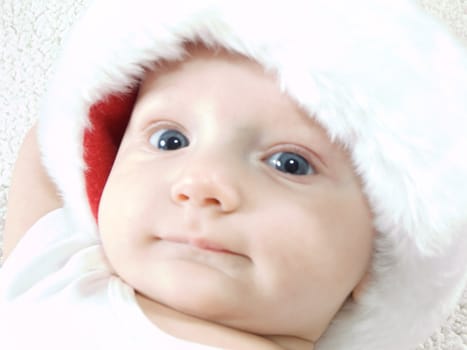 Young baby boy wearing santa hat and smiling