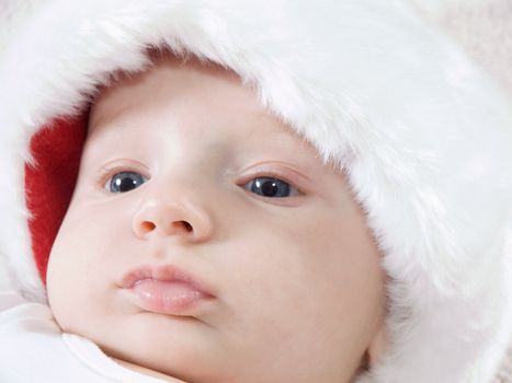 Young baby boy wearing santa hat and smiling