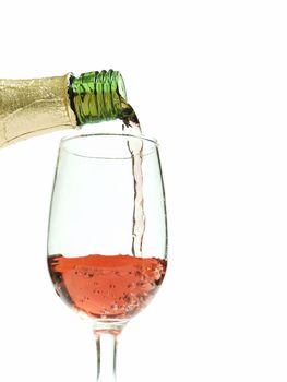 Glass of wine / champagne being poured with a white background