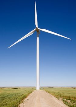 A close up of a wind turbine on the flat prairie