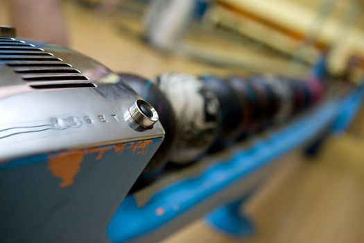 A detail of the reset button on an old bowling ball dispenser.  Shallow depth of field is used to isolated the button.