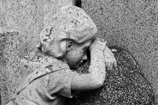 Statue of a crying girl at a grave in Central Cemetery / Vienna / Austria