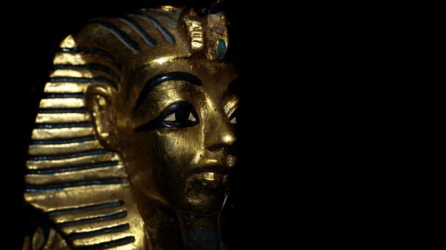 Gold mask motif of the ancient boy Pharaoh in Egypt