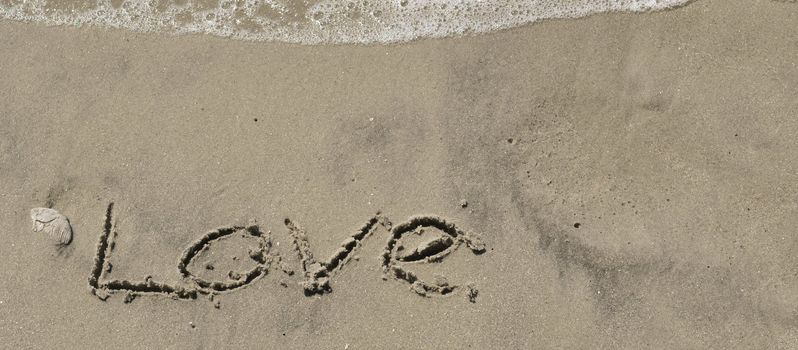 Love written in the sand with wave 7