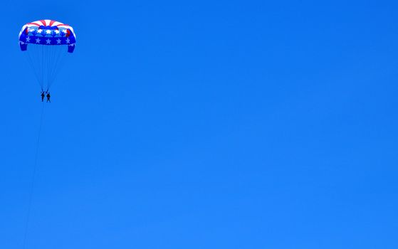 Parasailing against a blue sky