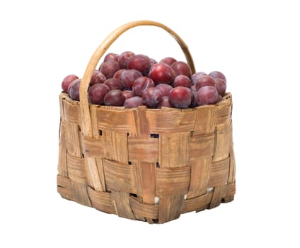 Wattled basket with ripe plums it is isolated on a white background.