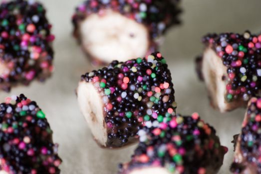 Delicious chocolate covered bananas with colorful sprinkles