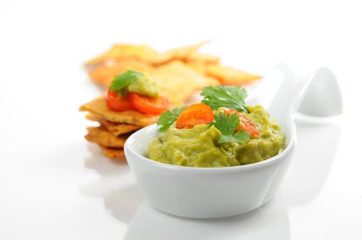 Fresh homemade guacamole served with backed chips.