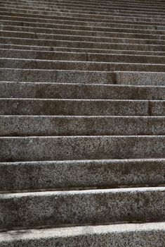 Focused near steps with many upward leading stairs in background