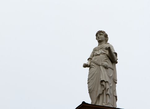 Courthouse statue of Themis Goddes of Justice missing sword and balance