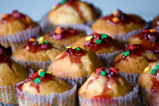 tilted plate of cupcake with colorful sprinkles