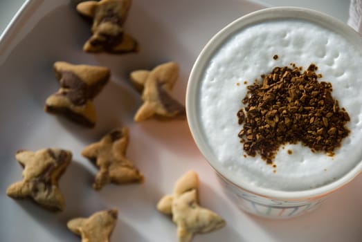 coffee with milk and cookies on plate