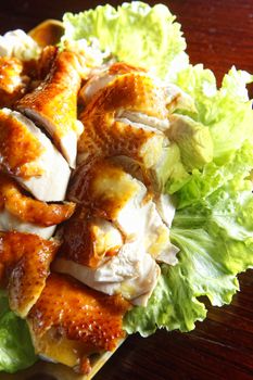 Chicken with lettuce on the dish.