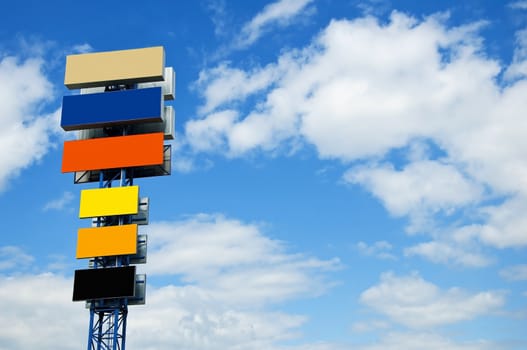 ulti-coloured billboard on a background of the blue sky with clouds