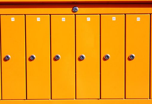 Yellow letterboxes maded from steel have stainless locks