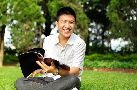 man chat and smile with book outdoor