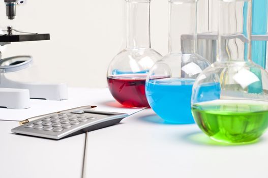 workplace employee lab,flasks with colored liquids, laboratory items