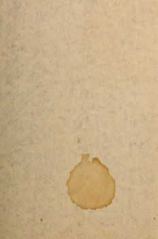 Page of old run-down paper with a stain