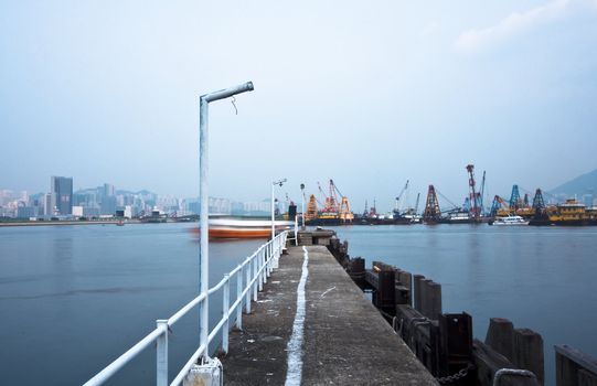 Deserted jetty at a foggy sea near a dutch city. hongkong