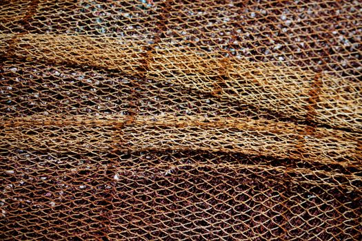 Close view of apile of some fishing net on the docks.