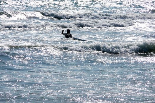 A man who is surfing off the Brighton Coast.