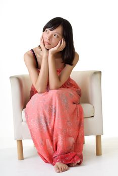 Asian beauty sit on chair and thinking on white background.