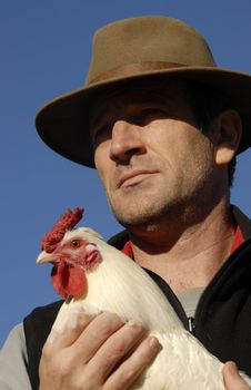 beautiful french man with hat and his white chicken 