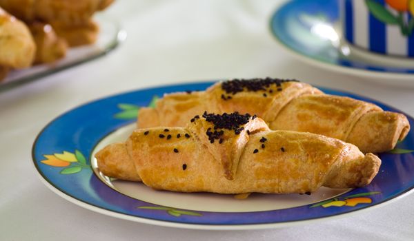 Scone with sesame seeds on a plate.