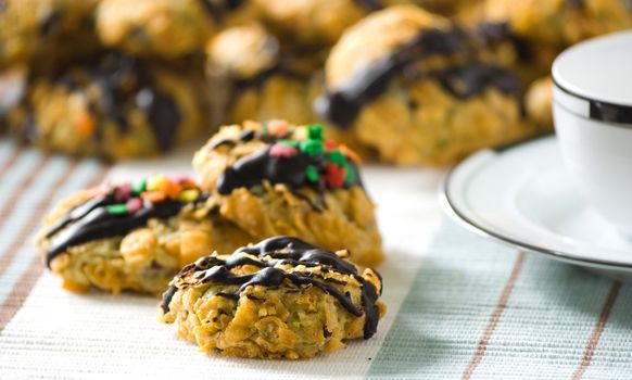 Cornflakes cereal cookies with chocolate sauce and colorful sprinkles