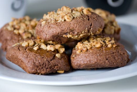 Plate of chocolate cookies with hazelnut.