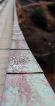 Road and pedestrian walk on bridge with green metal gaurd rails