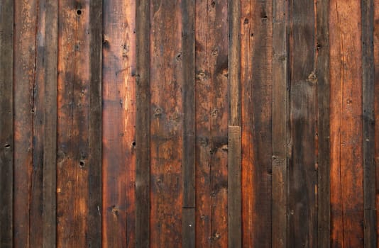 Old dark red and brown stained wood wall