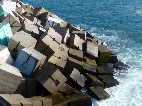 A view of the sea defenses in Gran Carnaria where someone has painted part of the defense to look like a present.