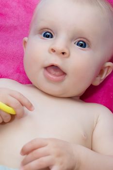 Blue eyed baby girl closeup suprprised portrait