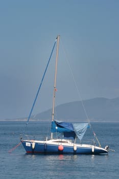 blue sail boat at the sea