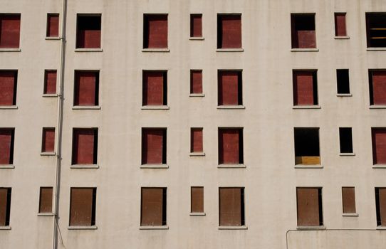 A wall full of boarded up windows