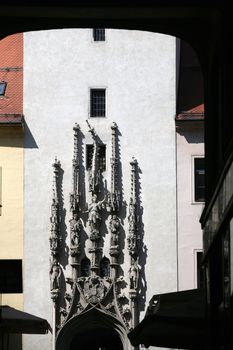 Sculptures on pylons with signs of gothic architecure over the church entrance