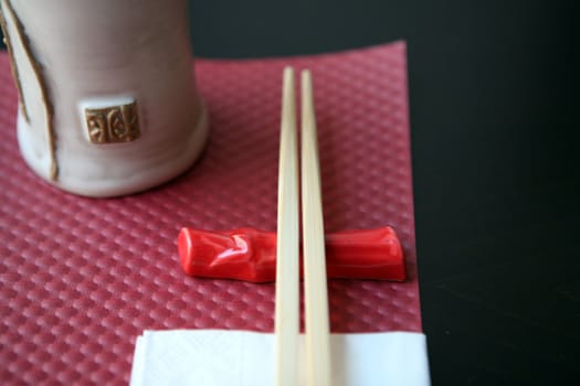 Pink and white place setting for asian food with  chopsticks