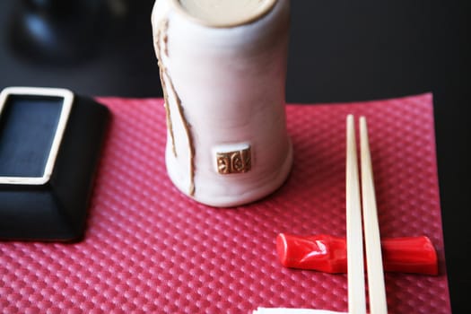 Pink and white place setting for asian food with  chopsticks