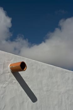 Ceramic pipe protruding from the wall, Teguise on Lanzarote Island, Spain.