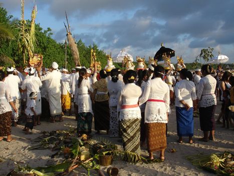 Balinese pilgrims attending a religious ceremony on the beach, Kuta beach, Bali, Indonesia.