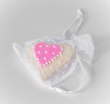 White mesh bag fills with heart shaped candy. Perfect for Valentine's Day