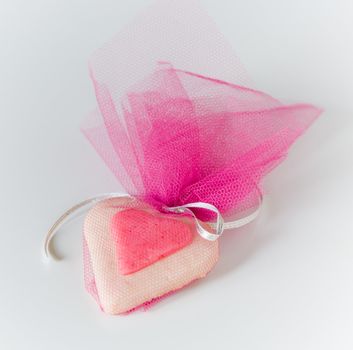 Pink mesh bag fills with heart shaped candy. Perfect for Valentine's Day