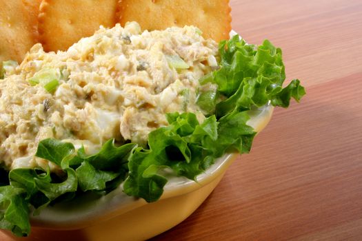 Tuna fish salad in a bowl with lettuce and crackers