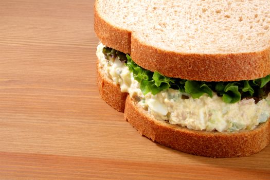 Tuna salad sandwich on wheat bread with lettuce