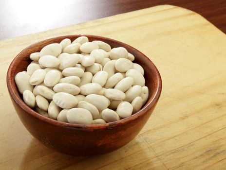 Organic Great Northern beans in a wooden bowl.