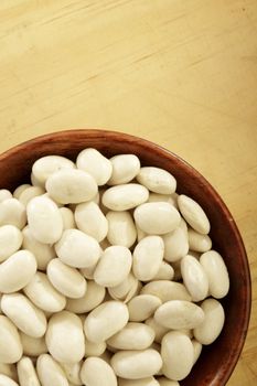 Organic Great Northern beans in a wooden bowl.